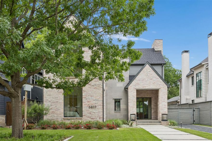 Nestled on a quiet, tree-lined street in the heart of Lakewood, this exceptional new construction by Dallas Newport Group blends timeless curb appeal with thoughtfully designed modern living. A welcoming front porch opens to a bright, open-concept layout where the kitchen, dining, and living spaces connect seamlessly. The chef’s kitchen is a true showpiece, featuring a built-in refrigerator, extensive custom cabinetry, a scullery, and a butler’s pantry that effortlessly serves the formal dining room—ideal for both everyday living and entertaining. Walls of windows and sliding glass doors flood the main living area with natural light and extend the space outdoors to a covered patio complete with a fireplace and built-in grill for year-round enjoyment. A secondary living area at the rear of the home offers flexibility as a den or private office, while a first-floor guest suite with an ensuite bath provides comfort and privacy for visitors. Upstairs, the oversized primary suite is a luxurious retreat, showcasing a spa-inspired bath with dual vanities, a soaking tub, a spacious dual-head shower, and a custom walk-in closet with built-ins. Three additional bedrooms, each with ensuite baths, a full-size laundry room, and a generous upstairs living area complete the second level. With meticulous craftsmanship, high-end finishes, and an unbeatable Lakewood location, this home offers a perfect balance of sophistication, comfort, and functionality.