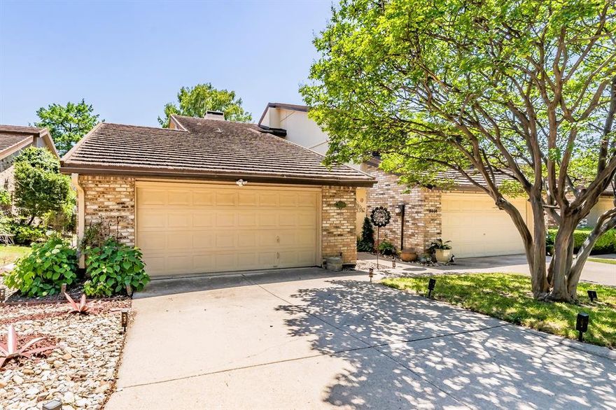 Welcome to this updated, beautifully designed single-story townhome in the heart of Fort Worth offering 2 bedrooms, 2 bathrooms, 2 dining areas, 2 patios and an exceptional blend of comfort, style and functionality. Step inside to a welcoming foyer featuring an upscale modern front door with keyless entry setting the tone for the elegant interior. The home is filled with abundant natural light enhanced by plantation shutters, soaring cathedral ceilings and a stunning skylight in the spacious living room. The inviting living area showcases a charming brick wood-burning fireplace with a cozy raised hearth perfect for relaxing evenings. Entertain with ease at the see-through wet bar ideally positioned to serve both living and dining spaces. The eat-in kitchen is a chef’s delight complete with stainless steel appliances, double oven, refrigerator, ample cabinetry and generous prep space. Custom plaster walls and high-end decorative lighting add a sophisticated touch throughout, while abundant storage ensures everything has its place. The large primary suite offers a peaceful retreat with an ensuite bath featuring dual sinks, a soaking tub, a separate shower and an oversized walk-in closet. Enjoy outdoor living with two private open-air patios, a charming front porch garden with a rainwater collection system, and lush landscaping in the backyard. Additional highlights include an attached 2-car garage, new gutters, new fence along the entry, sturdy stone-coated steel metal roof, and updates galore! Ideally located just steps from the community tennis court and pool, this home combines low-maintenance living with premium amenities. Conveniently positioned off I-30 near Hwy 820 interchange for quick access to Arlington, Fort Worth, DFW Airport, AT&T Stadium, and surrounding areas while being nestled in a serene setting with lush landscaping, tree lined street and a luxury lifestyle feel. A rare opportunity to own a stylish, move-in-ready townhome in the thriving DFW market.