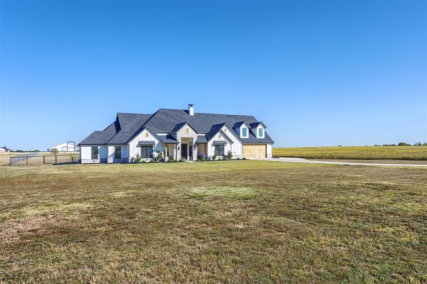 Welcome to 1810 J.C. Maples Rd in Gunter—a true Texas gem loaded with upgrades inside and out! Set on 1.78 acres, this beautifully designed 4-bedroom, 2.5-bath home offers two spacious living areas, a private study, and a 6-car garage built for those who need room for everything. Step inside and be wowed by the open layout, split-bedroom design, and stamped concrete flooring throughout. The chef’s kitchen steals the show with a commercial-grade 6-burner cooktop and built-in grill, drop sink, custom cabinetry, and a massive island perfect for cooking, gathering, and entertaining. Out back, experience outdoor living at its finest—a built-in kitchen, stone fireplace, and even a putting ring for golf enthusiasts. The east-facing backyard means cool shade in the evenings, ideal for relaxing or hosting summer get-togethers.
This home delivers luxury, functionality, and Texas charm all in one—the most sought-after floor plan in the state, upgraded top to bottom. Don’t miss this one-of-a-kind property built for those who want it all!
