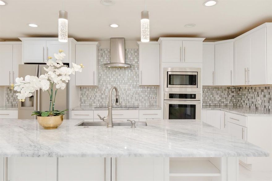 This beautifully updated Arlington home blends modern finishes with everyday warmth, offering an open-concept layout and a kitchen that truly steals the show. Think rich flooring, sleek stainless steel appliances, an oversized island ready for celebratory moments + holiday spreads, and stunning marble counters that glow under soft evening light.
The vaulted living room invites you to unwind by the cozy fireplace. The primary suite feels like a retreat, complete with a gorgeous custom walk in closet, and stunning walk-in shower framed in glass and gold finishes throughout. Both bathrooms carry the same elegant touches. No carpet anywhere! Fresh paint. Foundation repairs completed, engineer's report available. Purchase with confidence! 
Located in the heart of Arlington, minutes from dining, shopping, entertainment, and just a short distance to nearby schools. This home offers convenience, comfort, and style in one beautiful, welcoming package.