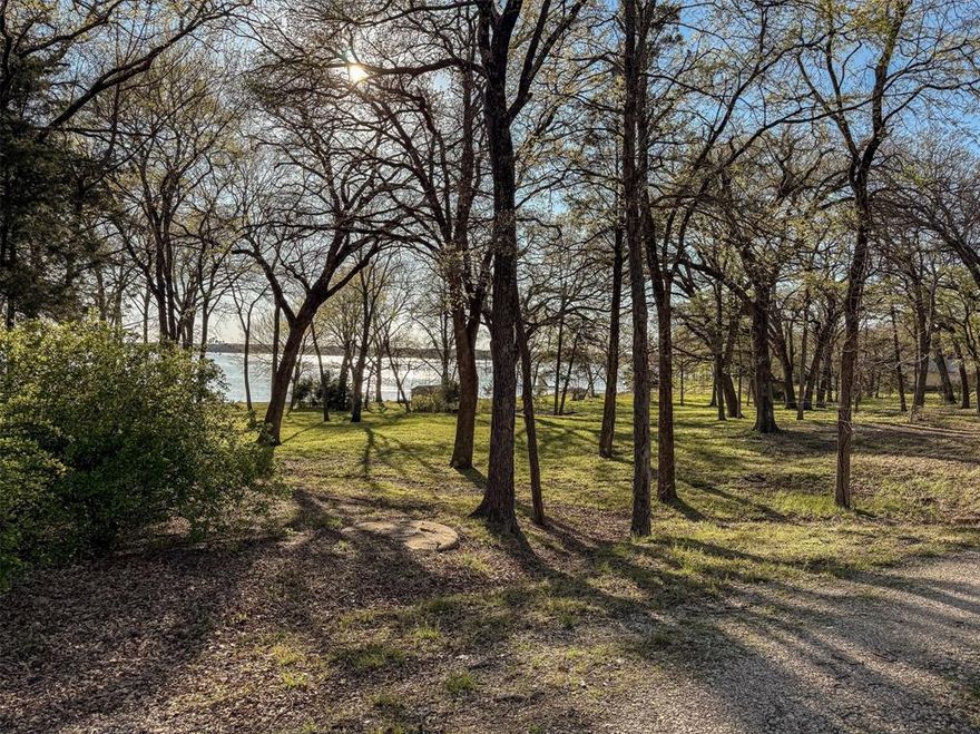 Looking for the perfect lake community to build in? You have found it! LOT 6 is 0.553 acres and would be the ideal spot to start! LOT 5 and 7 are also available. See MLS 20876321 and MLS 20876413. Enjoy the tranquility of life outside the city limits while taking in captivating views of Lake Tawakoni. The secure gated community offers fantastic amenities, including a refreshing pool, tennis court, fishing pier and boat ramp. Don’t miss out on this perfect spot to create your ideal living space. Septic required. Sabine River Authority must approve septic design. Call listing agent for list of septic engineers. Cash Water states water is available for lots 5, 6 and 7. FEC is electric provider. HOA docs on transaction desk. No Mobile Homes. Each lot is marked with white flags. MC Design also has a sign on each lot. Choose your own builder. Lone Oak ISD. Photos marking the land are approximate. Stakes are approximate. Buyer and buyer's agent to verify all information. 2 additional lots available on S Oaks Lane.