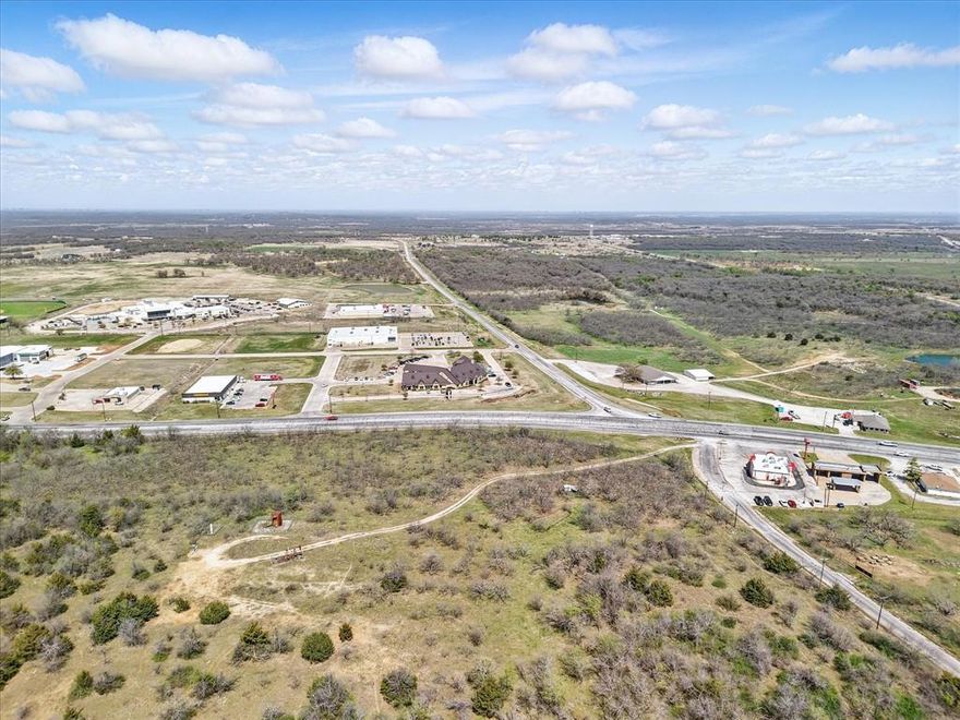 Over Six Acres at under Eight Per SF, at the intersection of Hwy 281 and FM 148 in Jacksboro.  This is some of the most Highly Visible, Desirable and Accessible Commercial Land in Jack County with close proximity to a major hospital, restaurants, car dealership, a bank and so much more.  This is the key lot of three lots totaling approximately 23.95 acres for future commercial, and potential for mixed use.  Please also look at adjacent property listings for expanded acreage availability and uses.