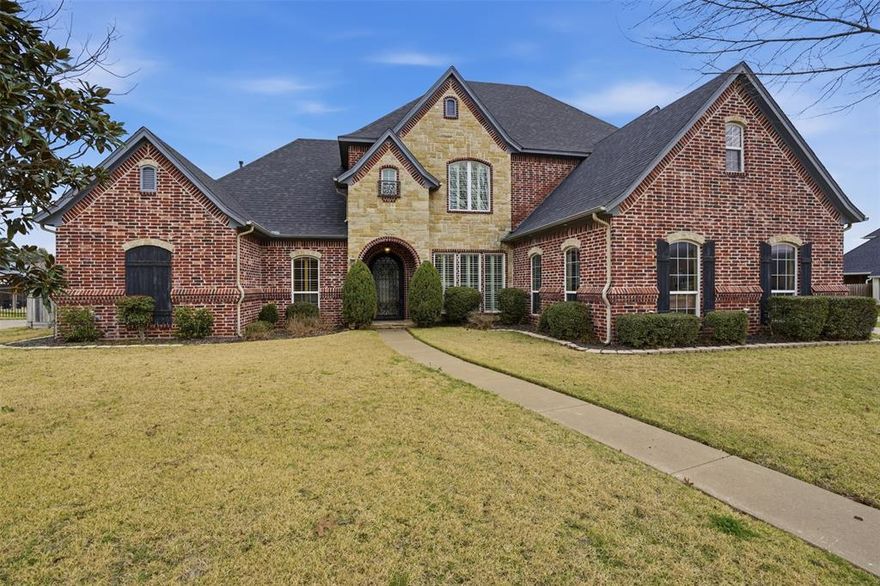 This home wows you with  luxury and elegance of this custom-built, one-owner home boasting 3 bedrooms, 3 baths, and thoughtful design throughout. Plus designated office area with  french doors. The brick and stone façade complements the tall entrance and custom iron door, radiating curb appeal. Inside, plantation shutters, warm wood flooring, and elegant ceramic tile grace the spaces, while natural light pours in through large windows. A well-appointed kitchen offers granite countertops, an island, and built-in appliances, pot filler. Entertain effortlessly in the family room with built-ins and a cozy fireplace. The primary suite features an ensuite bath with separate shower, soaking tub, and an expansive walk-in closet. Upstairs, two bedrooms share a Jack and Jill bath, and a bonus third living-loft area awaits. Outdoors, a private oasis with an in-ground pool, diving board, and fully equipped outdoor kitchen underneath a covered porch awaits.