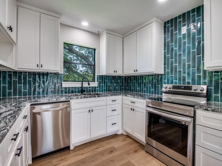 This stunning three-bedroom, two-bath home sits on a spacious double lot and has been completely remodeled from the studs in 2023. Imagine relaxing on the expansive 25x8 front porch during warm summer evenings. Step inside to discover an inviting open-concept living, dining, and kitchen area, perfect for entertaining. The living room features custom built-ins, while the kitchen dazzles with granite countertops, a stylish tile backsplash, stainless steel appliances, an undermount sink, and abundant storage. Down the hall, the second bedroom offers a built-in desk, ideal for work or study. The third bedroom boasts a pocket door to the bathroom and double closets for extra convenience. Retreat to the primary suite, complete with an ensuite bathroom featuring a double-headed shower and a spacious walk-in closet. The utility room includes built-in cabinets for added organization. Out back, enjoy the covered 20x13 porch overlooking a generous backyard, complete with a charming chicken coop that stays with the home. Come make this beautiful home yours today!