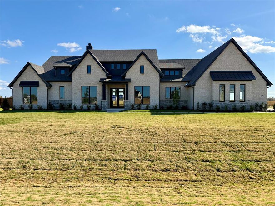 OPEN HOUSE SAT 11A-1P & SUN 2PM-4PM. Timeless design meets uncompromising quality in this custom spec home crafted by Opulent Homes, situated on 1 acre, moments from Lake Waxahachie. 3,647sqft of luxury living space, 4 beds, 3.5 baths, game room, & study - every detail has been thoughtfully considered to create a sanctuary of elegance and comfort. Step inside to an open, airy living space, & soaring 19.5ft vaulted ceiling accented with expansive windows & a 42in wood burning stone fireplace with gas connection that invites warmth & style. The chef’s kitchen features all-wood, soft-close cabinetry extending to the 12ft ceiling, quartz counters, & oversized island. Premium appliances, a hidden walk-in pantry, & thoughtfully integrated storage make everyday living effortless. Oversized back patio featuring a 42in brick fireplace creates the perfect backdrop for outdoor living & entertaining. Primary suite features custom closets with fully adjustable 24in deep shelving, his & hers built-in dressers, & separate F-5 rated storm room for added security & safety. Spa-inspired primary bathroom includes dual vanities, custom cabinetry & quartz, a soaking tub, & expansive walkthrough shower with level 4 tile to the ceiling. 3 spacious secondary bedrooms offer generous closet space, and one of the bedrooms has its own private ensuite bath, perfect for guests or multigenerational living. Also included is a 500-gallon underground propane tank, gas cooktop, tankless water heater, and gas stub for future outdoor cooking. Conveniently located neighborhood, offering a perfect blend of country living & nearby city amenities. Bring family & friends to Lake Waxahachie for boating, jet skiing, fishing, & swimming. Enjoy a walk around the Historic square in Downtown Waxahachie & take in the sights, shopping, & restaurants. No detail was overlooked in this home – with its dedication to luxury without compromise. Schedule a private tour & experience the Opulent difference! Ready early Dec.
