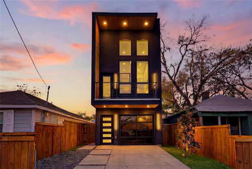Welcome to 2331 Lowery St, a striking 3 story contemporary home in the heart of Dallas featuring a sleek stucco exterior, oversized windows, and a private balcony for standout curb appeal. Inside, enjoy soaring ceilings, abundant natural light, and an open concept layout. The designer kitchen boasts custom cabinetry, Taj Mahal quartz countertops, stainless steel appliances, and a waterfall island perfect for entertaining. A private first floor bedroom with separate side access offers ideal flexibility for guests, multigenerational living, or rental income.

High end finishes shine throughout with designer lighting, a dedicated office with custom built ins, an upstairs loft, and a spacious primary suite with a custom closet and spa like shower. The LED lit tandem garage with epoxy floors and Tesla charger adds both function and style. Located just minutes from Downtown Dallas, dining, and major highways, this home offers modern luxury with built in investment potential.