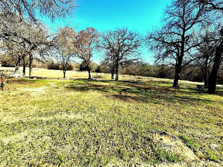 Welcome to your slice of Texas freedom in Azle—where wide-open skies meet unlimited potential. With NO RESTRICTIONS and located outside city limits (ETJ), this property offers the flexibility to create exactly what you envision, whether it’s a working ranch, weekend retreat, or multi-generational family compound. Set back off the road for added privacy, the property is accessed by a long gravel and rock driveway. Wildlife is abundant, with deer, turkey, and more frequently roaming the land, adding to the true Texas ranch experience.

The centerpiece of the property is a 40x60 shop already plumbed for a 2-bedroom apartment, perfectly positioned overlooking one of the tanks stocked with seasonal catfish—ideal for relaxing evenings or future homestead living. The large tank near the front features a fishing dock that is in need of a little repair, while a spring-fed tank sits toward the back of the property, enhancing both beauty and functionality. Additional improvements throughout the property provide endless possibilities, including a 20x40 lean-to ready to be converted into a barn and two 40x8 containers covered by a metal roof that could easily be transformed into additional barn space or storage. The property is fully fenced, gated, and equipped with cattle guards, making it ready for livestock. Multiple RV hookups are already in place, along with four septic systems, offering flexibility for guests, rental opportunities, or extended family living. Modern convenience meets rural living with 8-conductor fiber internet available at the front gate, a rare and valuable feature. 

This property is more than land—it’s an opportunity to build a lifestyle. With ample space, existing infrastructure, and complete freedom of use, the possibilities are endless for a private retreat, income-producing setup, or a true Texas family compound.

NOTE: Mineral rights do not convey. Seller requires 24-hour notice for showings. Listing agent must be present for all showings.