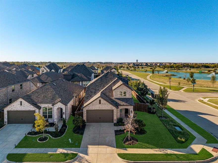 This oversized corner lot with views of the pond and amenity center is, without a doubt, one of the best locations in the entire Sandbrock Ranch community. Featuring a versatile floor plan with 4 bedrooms and 3.5 bathrooms, this home is thoughtfully designed for both entertaining and everyday living. The kitchen offers double countertops, custom cabinetry, and upgraded finishes, flowing seamlessly into the open living and dining areas. Natural light fills the home through the extended dining windowsill and the bay windows in the primary suite, highlighting the beautiful views beyond. Enjoy the amenity center within walking distance and relax while overlooking the pond and fountain. Sandbrock Ranch offers resort-style amenities including pools, a fitness center, fishing ponds, a treehouse, walking and biking trails, and spacious dog parks. This home combines luxury, comfort, and a prime location in one of Aubrey’s most desirable master-planned communities.
