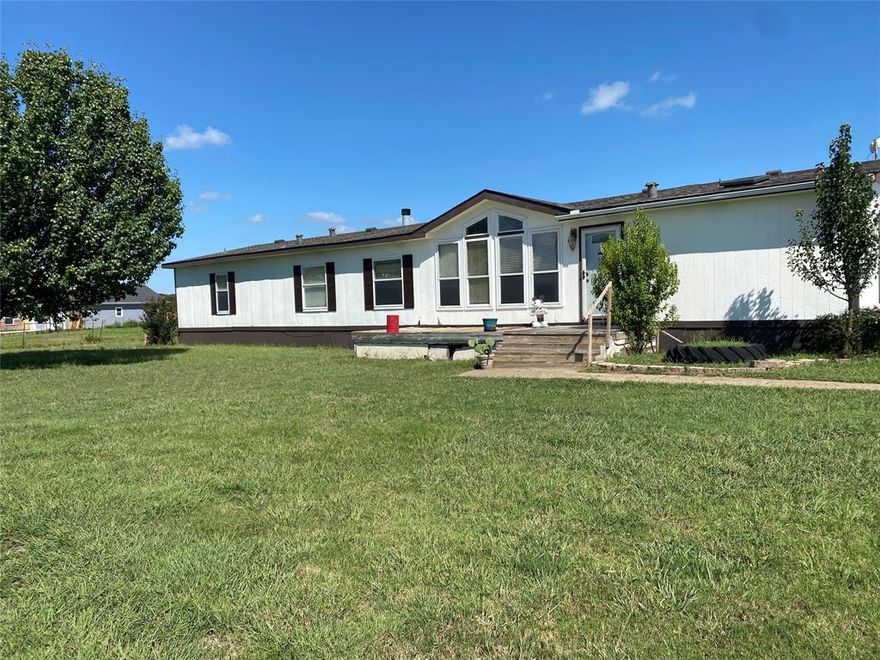 Seller is offering a 5K allowance with acceptable offer. 
2.26 Acre property in sought after Caddo Mills school district. Double wide mobile home which is 4 bedroom 2 full baths, master split floor plan with 2 living areas and wood burning fireplace. No HOA with horses allowed.  Property also features a 3 car garage built on site with electric, can be used for a shop or storage. New hot water heater, backyard fire pit, 16X10 storage building.  Entire property is fenced with a gated entry. 
This is also a great opportunity to build your dream home.