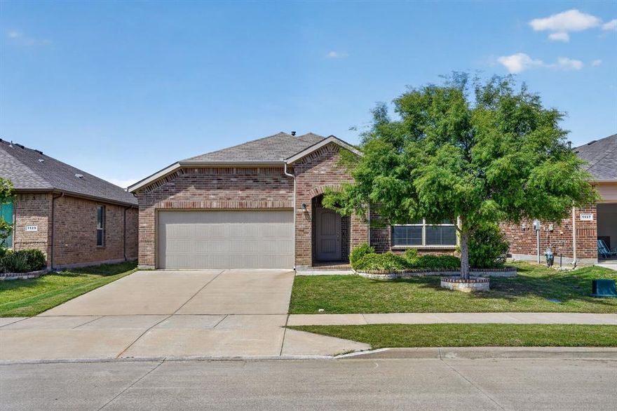 Beautifully maintained 4-bedroom single-story home in Hawthorne Meadows, just minutes from Alliance Town Center, Presidio, and major commuter routes in the Northwest ISD corridor. Built in 2018, this home offers a practical open layout with generous living space and a split-bedroom arrangement that works well for both everyday living and entertaining. The kitchen is the centerpiece of the home, featuring granite countertops, a large island with seating, gas range, abundant cabinet storage, and seamless flow into the dining and living areas. Neutral finishes, high ceilings, and oversized tile in the main living spaces give the home a clean, bright feel throughout. The private primary suite is tucked at the rear of the home and includes dual vanities, a separate shower, soaking tub, and spacious ensuite bath. Secondary bedrooms are well-sized and versatile, and there is a dedicated flex nook that works perfectly as a small office, study station, or homework space. Outside, the covered back patio overlooks a fully fenced yard with plenty of room to play, garden, or unwind. Located in one of North Fort Worth’s fastest-growing areas with convenient access to shopping, dining, and employers, this home offers comfort, location, and move-in-ready appeal. Come see it today!
