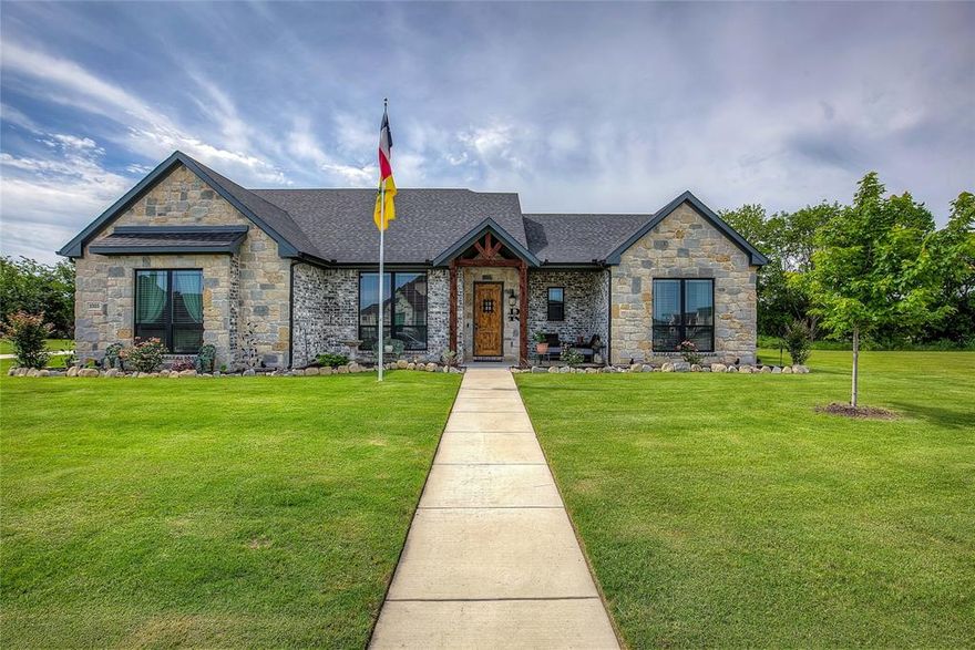 Welcome to this stunning custom home in The Mills, one of Caddo Mills’ most coveted communities. Set on a beautifully landscaped half-acre lot, this home impresses with striking stonework and an open-concept design.The gourmet kitchen features an expansive island and gas cooktop, flowing seamlessly into a light-filled living area overlooking the covered patio. 

The private primary suite offers a spa-level retreat with dual vanities, a walk-in double shower, and an oversized soaking tub. Two additional bedrooms are thoughtfully connected by a Jack-and-Jill bathroom. At the front of the home, a dedicated office or flex room offers inspiring views of the landscaped front yard—perfect for working, reading, or simply unwinding. The home includes a half bath to add convenience for visitors.

Additional luxuries include an extended garage accommodating a full-size truck, a built-in dog-washing station, and a dedicated dog run enclosed by an upgraded 8-foot privacy fence.

The owners are retiring to the country and ready to pass along their well-loved home to its next chapter!
