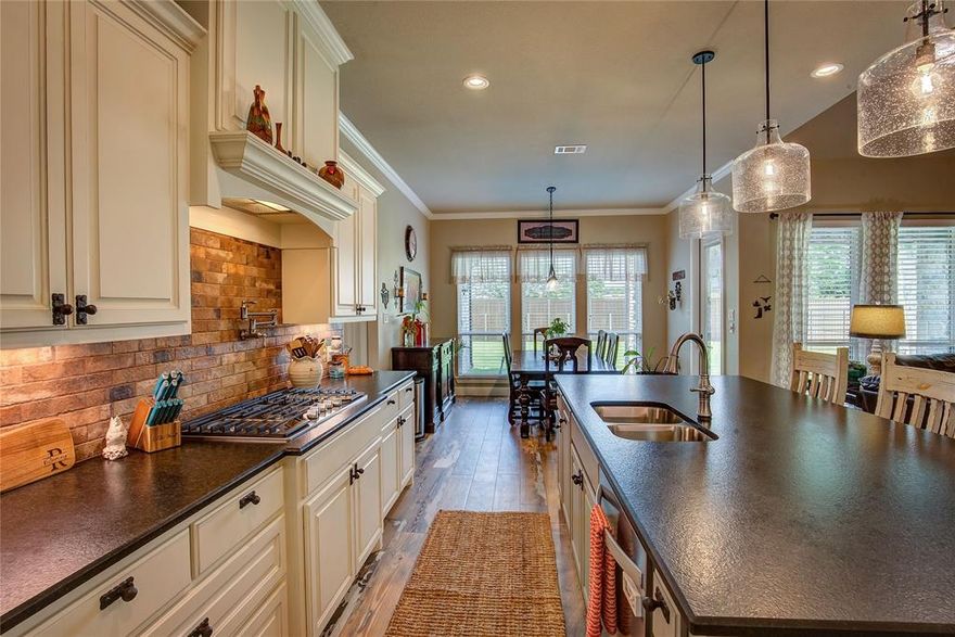 Welcome to this stunning custom home in The Mills, one of Caddo Mills’ most coveted communities. Set on a beautifully landscaped half-acre lot, this home impresses with striking stonework and an open-concept design.The gourmet kitchen features an expansive island and gas cooktop, flowing seamlessly into a light-filled living area overlooking the covered patio. 

The private primary suite offers a spa-level retreat with dual vanities, a walk-in double shower, and an oversized soaking tub. Two additional bedrooms are thoughtfully connected by a Jack-and-Jill bathroom. At the front of the home, a dedicated office or flex room offers inspiring views of the landscaped front yard—perfect for working, reading, or simply unwinding. The home includes a half bath to add convenience for visitors.

Additional luxuries include an extended garage accommodating a full-size truck, a built-in dog-washing station, and a dedicated dog run enclosed by an upgraded 8-foot privacy fence.

The owners are retiring to the country and ready to pass along their well-loved home to its next chapter!