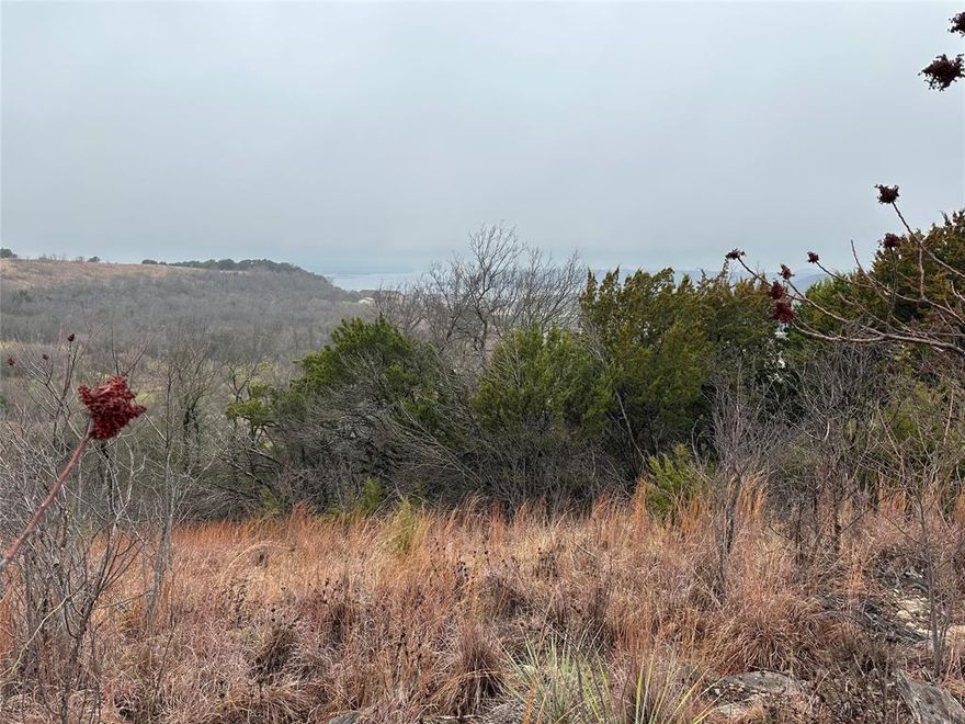 Excellent view of the surrounding area and onward to Possum Kingdom Lake. With no builder attachment and no building deadline, you can enjoy all of the community amenities while designing your dream home. This is an excellent established community with great amenities and lake access to one of the best recreational and fishing lakes in the State of Texas. Lot ownership permits the use of all of the neighborhood amenities including; boat storage, clubhouse with fitness center and pool, lakeside cabin with restrooms and kitchen, community dock, boat ramp, lakeside area with picnic tables, fishing pond, and twenty miles of private roads behind the gates.