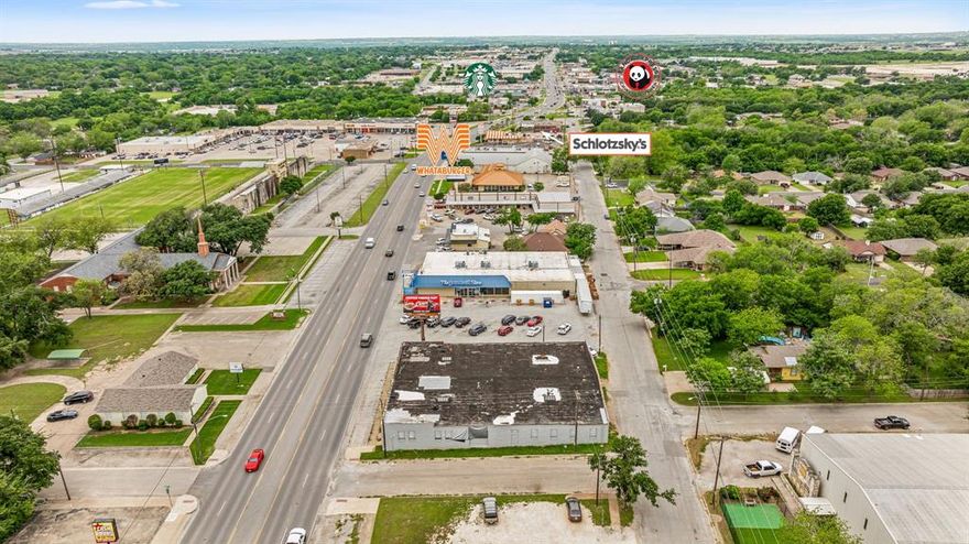 NEW PRICE! Location is the key to success. This property is offered at an incredible price. 7 Brew coming in across the street. Chipotle down the road. New business development all around. This site is right in the middle of town. Prime Commerical location with 3 sides of road frontage now available for sale. Located on the major thoroughfare in Cleburne with traffic count of over 23,000 daily. High visibility with 113 feet of frontage on Henderson. This was previously the site of Bob's Furniture for over 30 years. Huge open span warehouse could be revitalized into new furniture or mattress store, feed store, or your dream business here. Or demolish the building and this is THE location for Cleburne's next hit Attraction or Business. Cleburne's growth is exploding with several new housing developments and recent new restaurants and businesses. Olive Garden, HTeaO, Hobby Lobby, Smoothie King, Chick fil A, and more already investing in Cleburne. LED lighting recently installed, some updating in offices and restrooms, plumbing in restrooms updated and electrical in offices redone. Bring your vision to life in the heart of Cleburne.