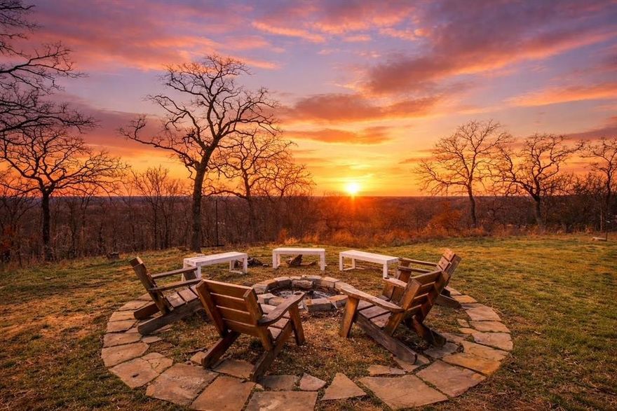 4 PRIVATE ACRES,PANORAMIC HILLTOP VIEWS, WORKSHOP,GUEST APARTMENT,POOL
Perched atop 4 private acres overlooking a scenic greenbelt with sweeping views toward Lake Lewisville and the Denton skyline, this rare hilltop retreat offers spectacular sunset views, exceptional privacy just minutes from Denton, shopping, dining, and the rapidly growing North Texas corridor.
The property features a 28 x 30 steel-frame workshop with electric, a separate 724 sq ft garage apartment, and multiple outbuildings-ideal for car collectors, hobbyists, entrepreneurs, or anyone seeking space and functional workspace.
Inside, the open-concept layout offers expansive living and dining areas with dramatic floor-to-vaulted-ceiling windows framing breathtaking backyard views. A private guest or mother-in-law suite adds flexibility for visitors or family.
The resort-style outdoor setting features a 54-inch deep pebble-finish pool with Baja shelf and attached spa, heated by propane and controlled through iAquaLink WiFi. A flagstone deck, covered patio, and outdoor sitting bar create the perfect setting for entertaining while enjoying the elevated views and unforgettable sunsets. The home also includes paid-off solar panels, providing reduced utility costs.
Above the garage, the 724 sq ft one-bedroom apartment offers flexible use as guest quarters, office space, or potential income-producing living space.
Outdoor amenities include a two-story storage garage with utilities, barn with loft inside a fenced area, putting green, horseshoe pits, outdoor fitness station, fire pit, elevated viewing deck among mature oak trees, walking trails, and a 100-yard range with deer stand.
The wooded acreage also features peach, apple, plum, pecan, and fig trees, raised garden beds, and a circular gravel drive with access to the workshop.
A rare opportunity to own elevated acreage with panoramic views and unmatched privacy in one of the fastest-growing areas of the North Texas Metroplex.