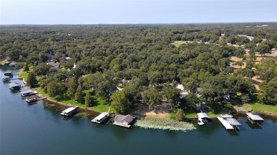 Build your vacation home or family retreat on one of the LAST remaining lake lots on Lake Athens! This is a rare opportunity to be on open water! Property has 130 ft of shoreline and is 0.56 acres including the 448. Located on deep water all year long with mature shade trees and expansive views. City services available and electric and water already in place. The enclosed boat house is grandfathered in and has electric doors with plenty of space for your boat, jet skis and lake toys. A 2 HP irrigation pump already installed. Convenient access to the Boathouse Bar and Grill. Located just 80 miles southeast of Dallas. Gorgeous lot and perfect location make this an ideal space to build!