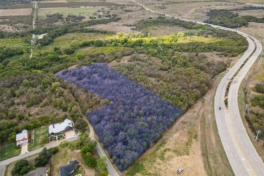 Discover a rare and remarkable opportunity to create your legacy estate on this expansive 5.95-acre homesite, ideally positioned along a prominent corridor in highly sought-after Flower Mound. Just minutes from the North Shores of Lake Grapevine and DFW Airport, this exceptional property offers the perfect balance of accessibility, seclusion, and natural beauty. Tucked behind heavily wooded Lake Grapevine Corp land, the setting is nothing short of breathtaking—offering peaceful privacy, scenic vistas, and frequent sightings of native wildlife. With ample room to design a true showplace, envision a grand residence, resort-style outdoor living, equestrian elements, or a custom workshop—all tailored to your vision. Adding to its long-term appeal, this premier location lies on the coveted west side of Flower Mound, home to the highly anticipated Furst Ranch master-planned development—a transformative, world-class destination set to bring an unmatched collection of upscale retail, dining, medical facilities, and luxury hotels just moments away. Future infrastructure improvements, including the planned expansion of Highway 377, will further enhance connectivity, providing seamless access to Westlake, Southlake, and Downtown Fort Worth. Located within the prestigious Flower Mound Cross Timbers Conservation District and zoned to highly regarded Argyle ISD, this property combines exclusivity with top-tier education. With land becoming increasingly scarce in Flower Mound, this is a compelling opportunity for discerning buyers, builders, or developers to secure a truly exceptional piece of North Texas.