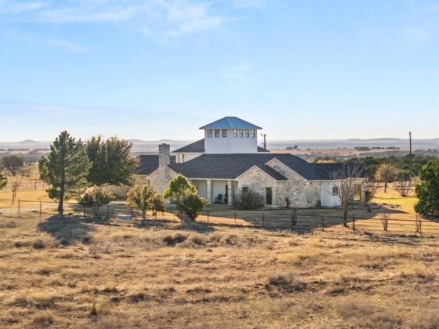 Not many properties stop you at the gate. Two Hawks Ranch does. Tucked off a paved road minutes from Hwy 84 in Coryell County, the outside world goes quiet the moment you arrive. Two stock tanks catch your eye on the drive in, rolling pastures open up on both sides, and the custom ranch house sits perched on the high ground ahead with views that earn every square foot of the drive. At 3,725± sq ft, the home has the bones you want and the finishes you'd expect at this level. Three living areas, hardwood floors, new carpet, high ceilings, and a floor plan built for real ranch life. The primary suite features dual walk-in closets, separate tub and shower, and dual vanities. A bonus room upstairs is ideal for kids, and a third-story observation room above that gives you the best vantage point on the property. Three-car garage rounds it out. The land matches the house. Four stock tanks total, with two larger ones deeper in the ranch holding water where the wildlife pressure is highest. The open pastures are healthy and productive, carrying cattle without ever being pushed too hard. Where the pastures give way, dense cedar breaks take over, giving the native whitetail exactly the kind of cover they need to stay put and thrive. Native grasses, a working windmill, and a deep water well complete a land package that has been stewarded with real intention. A historic stone storm shelter built well before the house stands as a reminder of the legacy this land carries. 9 miles to Gatesville. 40 miles to Waco and Temple. 90 miles to Austin. Turnkey and ready for its next steward.