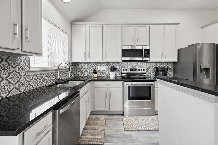 Stylish and completely updated, this beautiful home features an inviting covered front porch. The open floor plan with high ceilings creates the perfect space for entertaining. The spacious living room is centered around a cozy fireplace, while the modern kitchen boasts granite countertops, beautiful backsplash, stainless steel appliances, a pantry, and island. The primary suite offers a walk-in closet and a spa-like bath with double sinks, a jetted tub, and a subway-tiled shower. Three additional bedrooms provide ample closet space, while the full bathroom showcases sleek granite countertops. Updated lighting and ceiling fans enhance the home throughout, complemented by luxury vinyl plank flooring. An oversized garage offers ample storage, and the fenced backyard provides plenty of space to relax and enjoy.