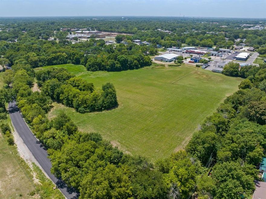 Looking for land to develop? Then take a look at this 10 +- acres inside Bonham City Limits.   Land has very low taxes as the current owner has ag use on it. There is approx. 1,000 ft of road frontage on Island Bayou and approx. 82 ft of road frontage on Center St.  City of Bonham has sewer lines and water lines on the property and electric lines are at the road. Land adjoins Legacy Furniture Store, a donut shop, a church and is close to Brookshire's Grocery Store, schools and convenience stores.