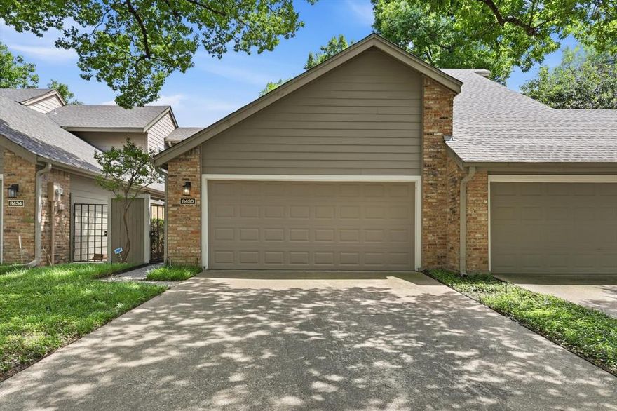 Hidden among towering mature trees and backing to a tranquil greenbelt and creek, this beautifully renovated residence offers a rare opportunity to experience a private, nature-inspired retreat in the heart of Dallas. Located within a highly sought-after community in Lake Highlands, that blends sophisticated updates with an effortless lock-and-leave lifestyle. From the moment you step inside, the home feels warm, elevated, and serene, designed for buyers who value both comfort and convenience. The expansive living room is anchored by a striking fireplace and framed by peaceful greenbelt views, creating an atmosphere that feels more like a luxury retreat than a typical townhome. Large windows invite natural light throughout while connecting the indoor and outdoor living spaces. The remodeled kitchen features timeless finishes, a newer range and refrigerator, brand-new dishwasher (2026), and updated fixtures throughout. Additional improvements, including two brand-new HVAC systems (2026), updated bathrooms, designer lighting, ceiling fans, and new carpeting, offer true turnkey living and peace of mind. One of the home’s most desirable features is its dual primary suite layout, ideal for modern living. Both bedrooms are generously sized with ensuite baths, while the upstairs owner’s retreat offers an additional flex space perfect for a private office or fitness area. Step outside to your private patio and unwind to calming creek views and extraordinary privacy rarely found in townhome living. Residents enjoy beautifully maintained grounds, a resort-style community pool, walking areas, and HOA-maintained landscaping and roof care for a truly low-maintenance lifestyle. Ideally positioned near White Rock Lake, premier shopping and dining in Lake Highlands, and major commuter routes including 635 and US-75, the home also benefits from highly acclaimed Richardson ISD. Elegant, turnkey, and surrounded by nature, this home offers an exceptional lifestyle.