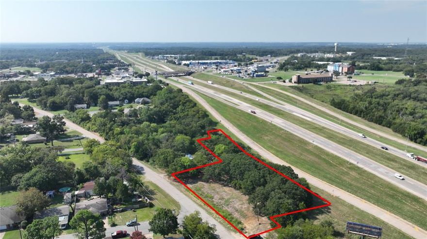 WHAT A GREAT SMALL ACREAGE OF 400 PLUS FEET OF HIGHWAY 75 ACCESS ROAD FRONTAGE ON THE NORTH SIDE OF FAST GROWING DENISON TX, ON THE EAST SIDE OF 75, JUST PAST THE MCDONALDS, BRAUMS AND BEST WESTERN.  1.14 ACRE TRACT IS ZONED COMMERCIAL.  IF YOU ARE LOOKING FOR A SMALL TRACT OF LAND WITH HIGHWAY FRONTAGE FOR YOUR NEXT BUILD, BE SURE TO TAKE A LOOK AT THIS 1.23 ACRE TRACT.  LESS THAN A QUARTER MILE TO RETAIL, DINING, MEDICAL, NEW QUIK TRIP, WHATABURGER, MCDONALDS, CHIC FILET PLUS MUCH MUCH MORE AND ALL WITHIN THAT QUARTER MILE.  NEW SURVEY WILL BE IN DOCUMENTS. 
ACCURATE LEGAL IS TWO PARCLES, POINT LOOKOUT ESTATE, BLOCK 2, LOT 35 & PT 34, AND ABANDONED STREET ROW PT ALLEY, ACRES 1.14 AND WITTENS ADDN, BLOCK 2, LOT PT 15, ACRES .0883
