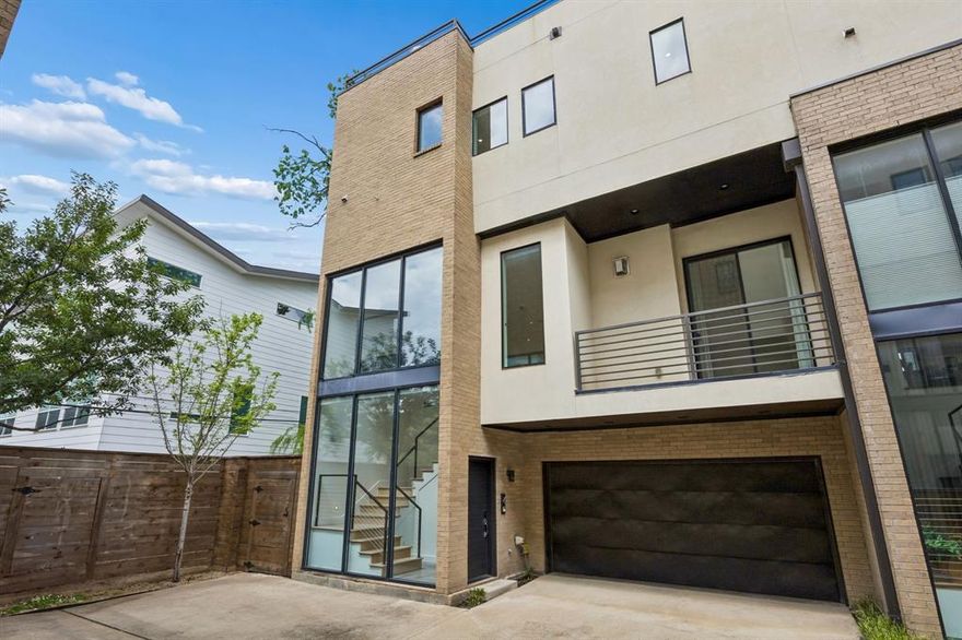 Gated modern end-unit condo in prime Lower Greenville, Knox-Henderson location with rare 3rd parking space. Recent updates include fresh paint and new carpet. Naturally lit interior with floor-to-ceiling windows and automatic window coverings. First level features private entry, 2-car garage, bedroom with built-in bed, full bath, and access to private backyard. Second level offers open-concept living, kitchen with SS appliances, refrigerator, quartz countertops, dining area, half bath, and balcony. Third level includes primary suite with spa-like bath and walk-in closet, plus en-suite bedroom and laundry. Fourth level rooftop deck with TREX decking and Dallas skyline views. Private backyard and multiple outdoor spaces—ideal for entertaining.
