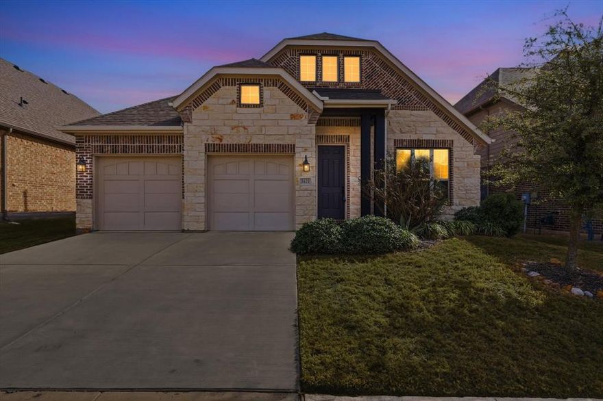 THE BEST VALUE CURRENTLY AVAILABLE IN CANYON FALLS, offering top-rated Argyle ISD and a highly functional floorplan. Walking distance to top-rated schools, this beautifully designed one-story home offers a seamless, low-maintenance floorplan. Built by Ashton Woods homes, this home offers 3 bedrooms plus a dedicated office. Featuring 9’ ceilings, hardwood floors, and an open-concept layout, the home is ideal for both everyday living and entertaining.

The private office with French doors provides a perfect work-from-home or flexible space. The gourmet kitchen showcases a spacious eat-in island, quartz countertops, gas cooktop, and a large pantry, opening effortlessly to the living area with a custom-tiled fireplace. Two secondary bedrooms and a full bathroom are conveniently located in the center of the home.

The split floorplan places the primary suite privately at the back, offering a peaceful retreat with a bay window. The primary bath features dual vanities, a soaking tub, and a glass-enclosed shower. Step outside to a covered patio—perfect for relaxing or hosting guests. Additional highlights include luxury lighting, a gas water heater, and a full sprinkler system. Garage with epoxy-coated floors for a clean, finished look.

Residents enjoy resort-style Canyon Falls amenities, including HOA-included cable and internet, miles of walking and biking trails, parks, clubhouse, fitness center, splash pad, infinity pool, dog park, and community gathering spaces such as the historic Hay Barn.

An excellent value and truly move-in ready—schedule your showing today.