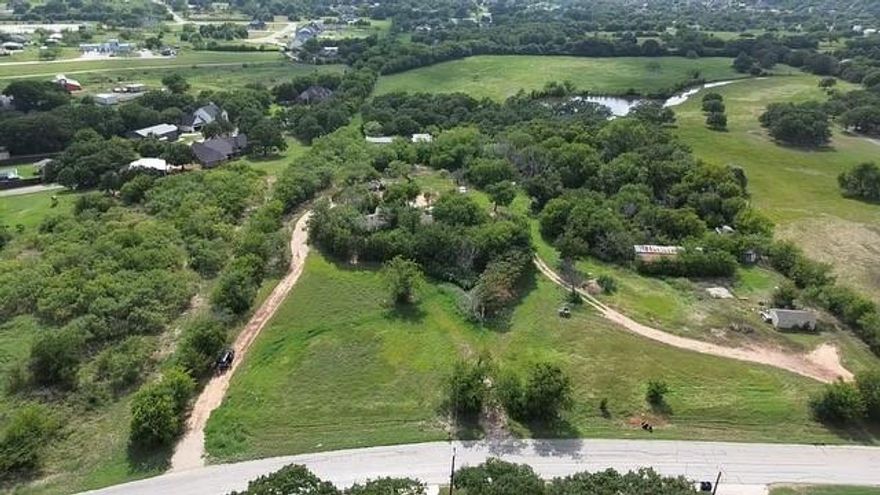 427' of road frontage on Rendon Rd. makes for great opportunity here!  This property would be perfect for a business park, storage or warehouse, RV or tiny home park or just your dream house! There is a SFH on the property with 3 bedrooms, 2 baths and 2638 SF but it will need a total renovation & systems overhaul for use. There is also a stock tank that's approximately 12-15 ft deep as well a 4-bay blocked auto-mechanic garage; each bay is 30Ft by 50Ft. Sellers use the stock tank for 100 yard rifle and pistol range practice or it could easily be stocked and utilized as a fishing pond, too! DO NOT WALK PROPERTY UNACCOMPANIED; SHOWN BY APPOINTMENT ONLY. There is no current survey.