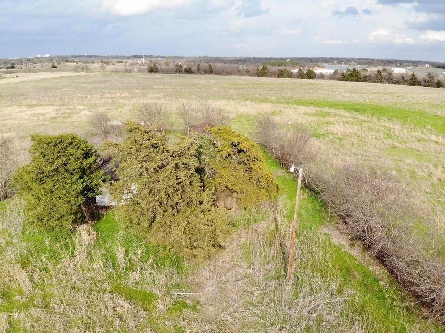 Discover the possibilities with this rare 30-acre opportunity just outside Ennis, Texas. Offered as two parcels sold together, this property features approximately 1,950 feet of road frontage & combines an existing homesite with expansive agricultural acreage, creating exceptional potential for rural living, investment, recreation, or future development. The first parcel, approximately 2 acres, includes an existing as-is home & barn. The residence will require significant renovation or removal, making this an ideal setup for buyers seeking an established homesite with room to build a custom home, restore the existing improvements, or create a private country retreat. The second parcel offers approximately 28 acres with a pond & is currently ag-exempt land used for hay production. This open acreage provides versatility for livestock, farming, recreational use, or simply enjoying the privacy & wide-open space that rural Texas living offers. Conveniently located just minutes from downtown Ennis, the property delivers the peace of the countryside with easy access to local shops, dining, schools, & major highways connecting to Waxahachie, Corsicana, & the Dallas-Fort Worth metroplex. It is also ideally positioned near Ennis Municipal Airport, Texas Motorplex, & Lakes Bardwell and Clark.
With 30 acres across two parcels, substantial road frontage, existing improvements, & productive agricultural land, this property presents a compelling opportunity to create a private homestead, weekend retreat, working ranch setup, or long-term land investment in growing Ellis County.

Buyer to verify utilities, zoning, acreage, exemptions, & development potential. Existing electricity service is set up. New owners will need to establish water service through Rockett SUD. Showings by appointment via SupraOne. Use caution when entering overgrown areas of the property. Parcels #190369 and #190368 to be sold together.