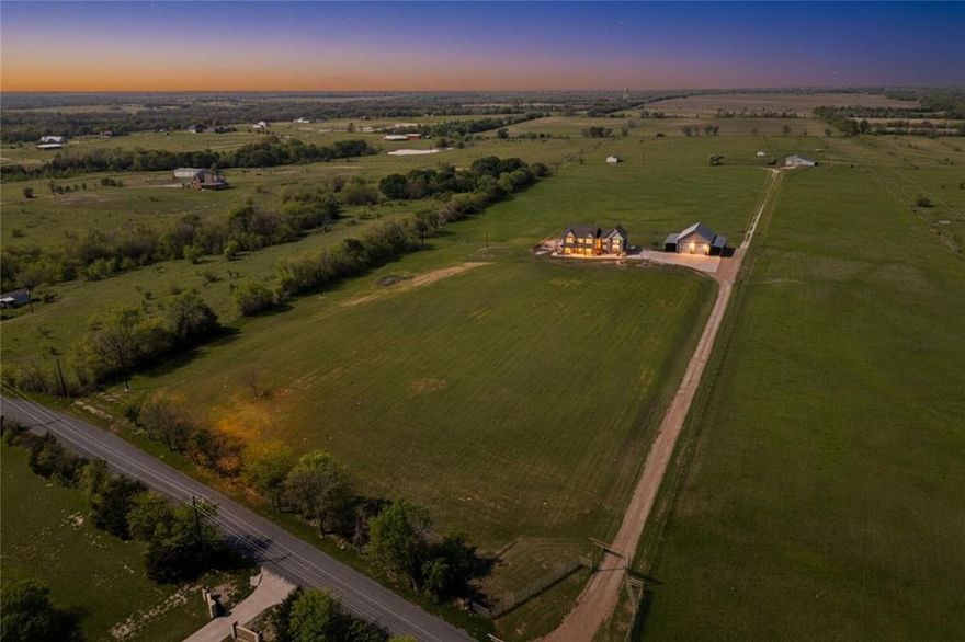 Experience wide-open Texas living without sacrificing luxury — a rare blend of flexibility and refinement on 11 ag-exempt acres just minutes from charming downtown Van Alstyne. At the heart of it all is a thoughtfully remodeled two-story home, extensively renovated seven years ago under one contractor. Updates include Hardie board siding, fresh paint, and Infinity® Ultrex® windows — known for their strength and durability that outlast traditional vinyl. Inside, you'll find oversized rooms filled with natural light, a chef’s kitchen with a WOLF range, built-in fridge, wine storage, and custom cabinetry.

Off the mudroom, a built-in storm shelter adds peace of mind for safety or storage. The primary suite offers a true retreat, with a private sitting area featuring custom built-ins — ideal for a reading nook, home gym, or lounge. Vaulted cedar tongue-and-groove ceilings with recessed lighting and a spa-like ensuite with garden tub, seated shower, and dual closets complete the space.

Outside, the lifestyle continues. The oversized 2-car garage is joined by a fully insulated 35x54 workshop with two carports — perfect for storage, hobbies, or business. A separate storage building adds even more utility, with electricity and water already in place. Modern comforts include full spray foam insulation, a smartphone-controlled HVAC system, propane-powered instant hot water, and a newly replaced hail-resistant roof (insurance discounts apply). The septic system is professionally serviced three times annually and includes an alarm. Termite protection and concrete pest barriers offer additional peace of mind. Whether you’re homesteading, hosting, or simply seeking room to breathe, this one-of-a-kind property is a true North Texas gem.

Looking for more land? Additional acreage is available — inquire for details.