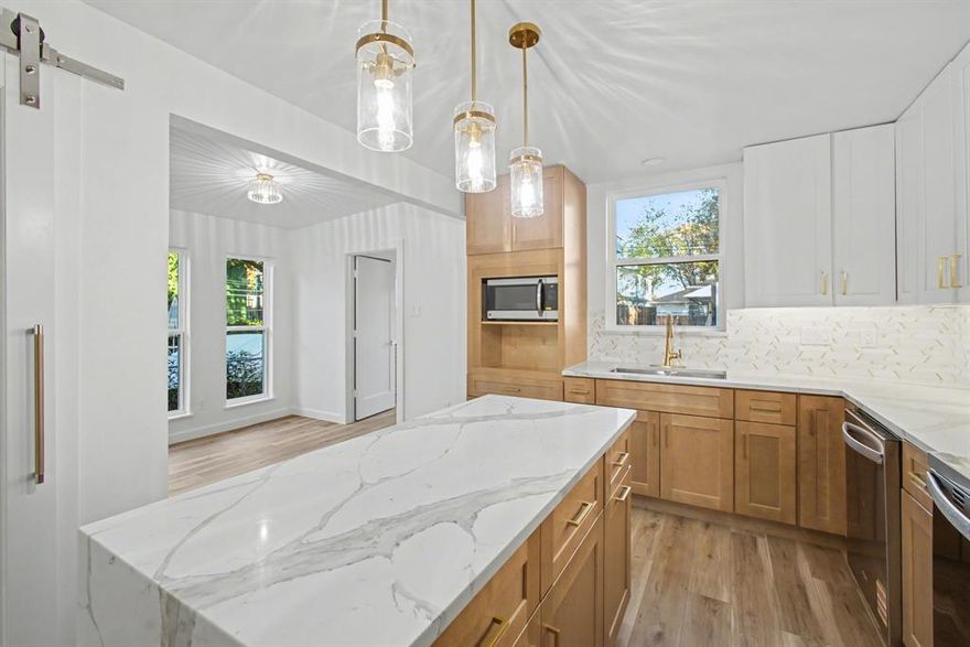 Fully remodeled 1948 home completed in 2025, offering modern luxury, new updated systems, and timeless design in Lovers Lane Heights Subdivision. Located in one of Dallas’ most desirable neighborhoods, this residence blends classic elegance with modern design. The main residence features 4 bedrooms, 3 full bathrooms, open-concept living areas, wide vinyl plank floors, abundant natural light, and a sleek electric fireplace. The designer kitchen offers custom cabinets, quartz waterfall island, stainless steel appliances, and a breakfast nook, with a separate dining room for added flexibility and entertaining. A private backyard with a 2 Car Detached Garage, and an additional bonus room and half bath off of the garage, creates a flexible space for a home office, fitness room, creative studio, or guest suite. This home is perfect for both family living and investment. To allow buyers to personalize the home, the seller is offering a $10,000 credit for custom closets from Closets by Design, applicable to all closets, the walk-in pantry, and a custom mudroom bench and shelving system. Additional highlights include a dedicated laundry room, upgraded windows, and a redesigned exterior with fresh landscaping and a welcoming front porch. Outdoor space provides room to relax or entertain, while the location offers convenient access to Love Field Airport, shopping, dining, and entertainment. Fully updated, flexible in design, and positioned to appeal to both owner-occupants and long-term investors, this home delivers quality, functionality, location, and long-term value.