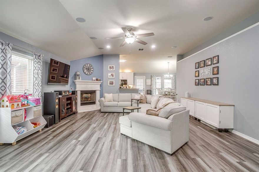 Adorable, MOVE-in-READY home in Keller ISD featuring a nice open floorplan with a corner fireplace in the living room, split bedrooms, and a second living area. Space currently being used as an office could be used as a play area or dining room. So many possibilities! Special feature in the bonus room...the projector and screen appear as furniture and they stay. Spacious primary suite is at the back of the house and features bay windows, ensuite bath with garden tub and seperate shower, double vanity with sitting area and an oversized walk-in closet with extra rods and racks. You can enjoy our Texas nights on your welcoming front porch or expanded back covered patio. Updates include: New HVAC and ducts 2025, laundry room reno 2025, roof and gutters 2021, Luxury Vinyl Plank flooring 2021, new carpet in secondary bedrooms 2025 and so much more. Ring Pro stays. Villages of Woodland Springs offers 6 pools, ponds, walking and biking trails, playgrounds and schools! Come take a look today.