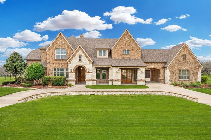 Tucked away on 1.69 private acres in Cedar Hill and located within highly sought-after Midlothian ISD, this stunning custom estate is where timeless architecture meets modern luxury. Recently extensively renovated from the inside out, the home blends classic craftsmanship with today’s most desired upgrades, creating a truly one-of-a-kind living experience. From the moment you enter, the open, thoughtfully designed floor plan welcomes you with spacious living areas and natural flow, perfect for both everyday living and entertaining. Every room feels intentionally placed, creating a home that is both elegant and comfortable. The layout offers three full bedrooms on the first floor, ideal for guests or multigenerational living. Upstairs you’ll find three additional bedrooms, including a private mother-in-law suite that provides comfort and independence.  Media room and game room upstairs with a balcony overlooking the backyard.
Step outside and discover a true backyard oasis. The resort-style setting features a sparkling pool and hot tub, all surrounded by a wrought iron fence and lush privacy shrubs that create a peaceful retreat. The outdoor living space was designed with entertaining in mind, complete with a new pergola, mounted TV, and built-in BBQ grilling area, perfect for hosting unforgettable gatherings or enjoying quiet evenings under the Texas sky.
As an original custom-built home, the property carries a level of character and quality rarely found today. Combined with the extensive renovation and stunning outdoor amenities, this estate offers the perfect balance of luxury, privacy, and lifestyle. An entertainer’s dream with an exceptional floor plan, beautiful acreage, and resort-style outdoor living, this is truly a one-of-one opportunity in Cedar Hill.