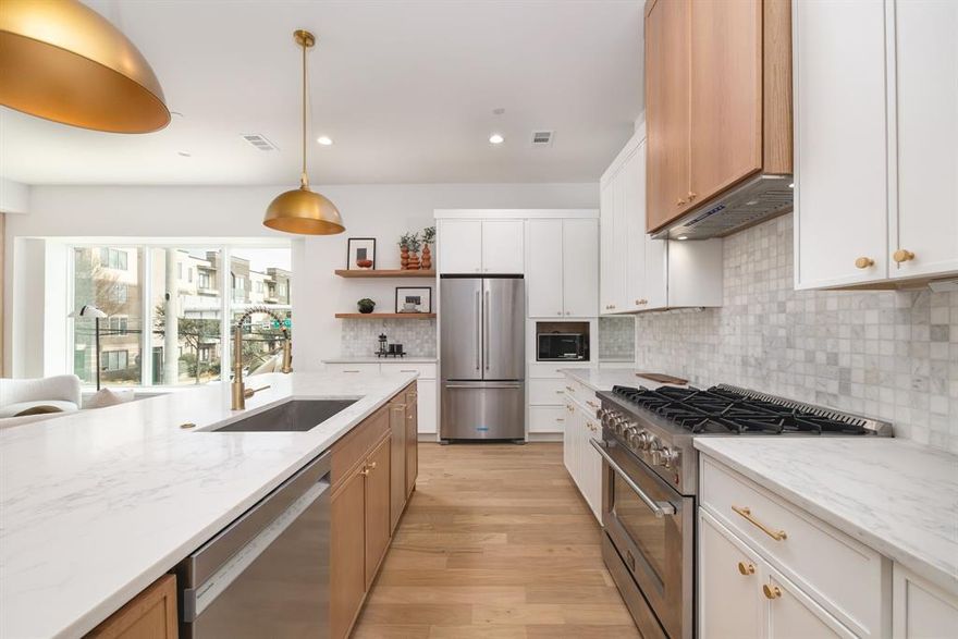 Crafted by the renowned Strange and Sons Development, Cedar Springs Townhomes delivers twenty one modern residences in the heart of Dallas. Interiors are bright and refined, planned for natural light and easy flow. The main level centers on a chef kitchen with white cabinetry, warm wood accents, brass hardware, and Calacatta style quartz on a generous island with an under mount sink. A marble backsplash, brass dome pendants, and a premium stainless package with a six burner gas range, hood, French door refrigerator, built in microwave, and dishwasher complete the space. The great room brings wide plank oak floors, a window seat, and sliders to a private balcony. Upstairs, a spa bath offers dual quartz vanities, oval mirrors, globe lighting, and brushed brass fixtures. The wet room is enclosed in frameless glass and places a freestanding soaking tub inside the shower for a true retreat, with walk in storage nearby. Many plans add a flexible loft for media, office, or guests, with floating shelves and a compact cabinet bar. Outdoor living shines with covered and open balconies, and select homes provide expansive rooftop terraces with a shaded pergola and city views. Architecture is clean and contemporary with strong curb appeal. From this central address you are close to Oak Lawn and Uptown dining and nightlife, the Katy Trail and Turtle Creek Park, West Village, Downtown, the Medical District, the Dallas North Tollway, and Dallas Love Field. Cedar Springs Townhomes pairs elevated finishes, flexible spaces, and a walkable location, with the craftsmanship of Strange and Sons Development.