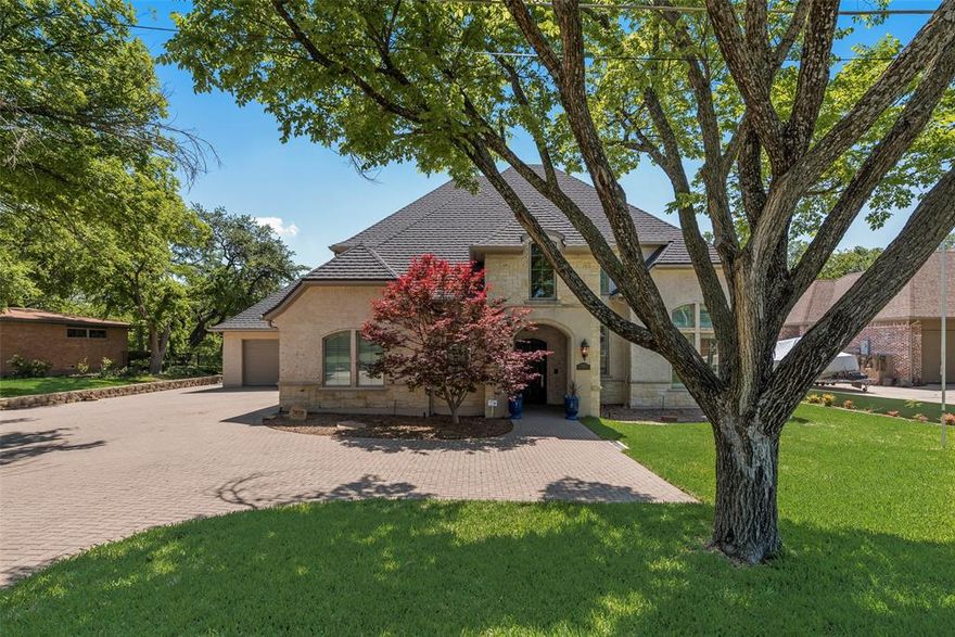 REDUCED AND WORTH IT!! Absolutely gorgeous custom home on a lush half acre creek lot with No HOA. Recently remodeled with no expense spared! Open floor plan. Large living room features beautiful fireplace and brand new mounted TV, opens to stunning kitchen and amazing outdoor patio with a motorized screen. Kitchen has dual dishwashers, double ovens, double Sub Zero refrigerator, commercial Wolf range, Sub Zero drawers, pot filler and 2 walk in pantries. Mud room has dry coffee bar. Primary bedroom is spacious and features a coffee station. One secondary bedroom downstairs and 3 bedrooms upstairs all of generous size and each having an ensuite bathroom. Brand new Tilcor roof with 5 point screw down and 50 yr warranty, Plantation shutters throughout, Tornado-Safe room with double doors, EMTEK hardware and locks throughout. Home has space and is utility ready for an elevator, home generator and EV charger. Backyard and patio are amazing and ready for that summer BBQ. Featuring a wood burning fireplace, motorized screen, built in grill, circular fire pit, and awesome views. Backs to White Rock Creek. New retaining wall and wrought iron fence.  This patio is ready to entertain!