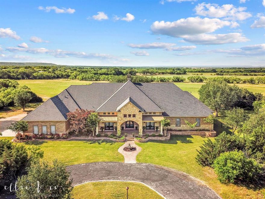 Welcome to this jaw dropping 183 acre TUSCOLA TEXAS RANCH gem! 2012 built 4BD 4.5BA meticulously designed 5,800+- sf home. Boasts 2 fabulous offices w exterior doors to front covered patio, hardwood floors, 14 foot ceilings. 3 living, 2 dining, mud room. Open concept, double propane FP for formal living & dining, gorgeous breakfast bar, gourmet kitchen w WOLF range, GE Monogrammer appliances, cabinet fronts, massive island, large walk in pantry w freezer space. Split primary en suite has spa like bath, walk thru double shower w dual thermostat control, soaking air bathtub w remote. Guest bedroom, private full bath. 2 secondary bedrooms w shared bath, walk in shower. Upstairs living w full bath, balcony, gated spiral staircase to back yard, walk in attic access.  Marvin Casement Wood Windows w aluminum ext. cladding, 6 inch crown molding, 10 foot ceilings, multi zoned HVAC w propane heat, custom wood shutters, Class 4 roof, ICF walls, chip sealed circle drive.  4 car garage w climate controlled hunting-storage room. Outdoor living, beautiful oak trees... fenced diving pool w water features, heated-cooled pool half bath, stained-stamped concrete patio across the back of the house, WB FP w propane starter, propane grill, WB grill w propane starter, cooktop, propane griddle, plus Green Egg.  Ready for livestock, includes covered working pens, 2 water wells, well water drinking troughs, fenced-cross fenced, solar powered electric entrance gate. 1,200 sf barndominium living w stained concrete floors, 2 bed, 1 bath, 1,200 sf insulated shop w two 12 x 14 overhead doors, open loft above living quarter, 1,650 sf drive thru RV storage w 14 foot rolling doors, 50 amp plug, sewer dump, air outlet. Breathtaking views of the land for watching wildlife including turkey, deer, hogs & sunsets! This property has it all, don't miss out! Less than 25 minutes S of Abilene.  One owner.  Jim Ned ISD.