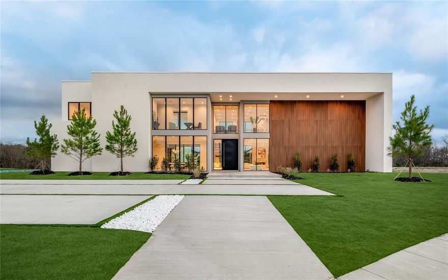 Villa Eterna - Ridge Lakes - Heath, TX Luxury Home.

Newly completed luxury home by Buisier Dev in the prestigious Ridge Lakes community of Heath, Texas. Positioned on a rare corner greenbelt lot, this new construction residence offers privacy, open views, and architectural presence within Ridge Lakes.
A 10-foot custom pivot door opens to a custom-designed interior with open-concept living defined by oversized stone slabs, curated handmade light fixtures, custom wall paneling, and a floating staircase framed by an indoor planter. The dramatic double-height living room features a three-sided Urbana fireplace and seamless indoor-outdoor flow through stackable glass doors.
The European-designed kitchen includes premium Miele appliances, sleek cabinetry, and a concealed hidden pantry — designed for both everyday living and entertaining.
The private primary wing includes a fireplace, steam shower, soaking tub, and direct access to the pool and spa. Upstairs, all secondary bedrooms are ensuite. A dedicated office opens to a terrace overlooking the backyard oasis.
The entire villa is smart-controlled and includes an integrated speaker system throughout the home.
The backyard features a Mediterranean-inspired pool, temperature-controlled elevated spa, covered outdoor BBQ kitchen, custom landscaping, and turf for low maintenance. Two separate driveways — including a dedicated guest drive-up pad — provide added convenience, in addition to the 4-car epoxy garage.
Move-in ready and thoughtfully executed, Villa Eterna presents a rare opportunity in Ridge Lakes, Heath, TX.