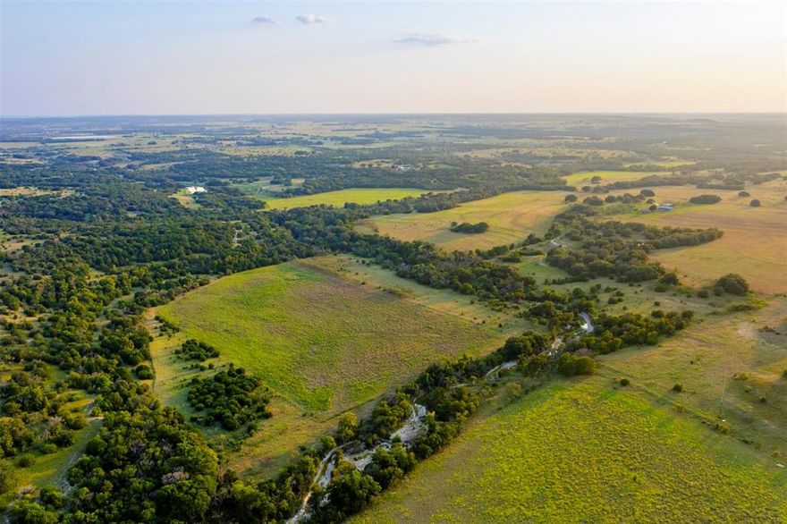 Welcome to Boxcar Creek Ranch, where water, wildlife, and wide-open Texas skies stretch across approximately 228.42 acres just outside of Hamilton. Within easy reach of Dallas, Fort Worth, Waco, and Austin, this property offers an exceptional setting to create your ideal Texas ranch.

Gholson Creek flows downstream across the property for an impressive 5,000 feet and is flanked by rolling pastures, scattered tree cover, and two livestock tanks. Rich in water and natural diversity, the land is ready to support cattle, horses, hunting, or recreation. From deer hunting in the hardwoods to fishing the tanks, trail riding by ATV or horseback, or taking in panoramic sunsets from the property’s high point, Boxcar Creek Ranch offers the space you need to live, work, and enjoy the land.

Improvements include a well-kept barn, horse stalls and pens, and the ranch’s namesake: a historic barn built from an old railway boxcar. This practice, popular in the mid-20th century, reflects the ingenuity and resilience of Texas ranchers who repurposed materials to keep their land thriving.

Boxcar Creek Ranch is more than acreage; it’s a place to gather, explore, and enjoy the best of Texas ranch living.