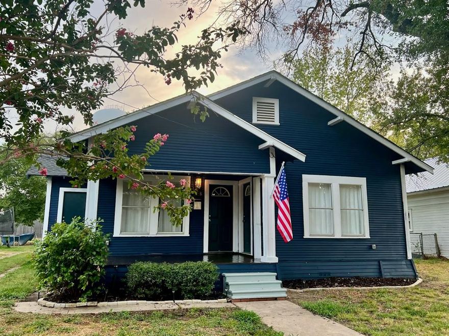 Incredible opportunity to own your first home in Groesbeck!  This fabulous two bedroom, one bathroom craftsman-style home is adorable with navy exterior and brass finishes.  The covered front porch is inviting for that morning cup of coffee and watching the sunrise.  On the interior, there are high ceilings with shiplap accents and original hardwood floors throughout the majority.  The kitchen has a peninsula with granite countertops and is furnished with plenty of storage.  The bathroom underwent renovation just a few years ago.  There are large walk-in closets and a separate laundry room area as well as pantry.  Around back, there is access to the two-car carport and would make a lovely backyard once fenced.  Additionally, this is a great location and is just around the corner from restaurants and shopping.  Home is priced to sell and ready for your personal touches!