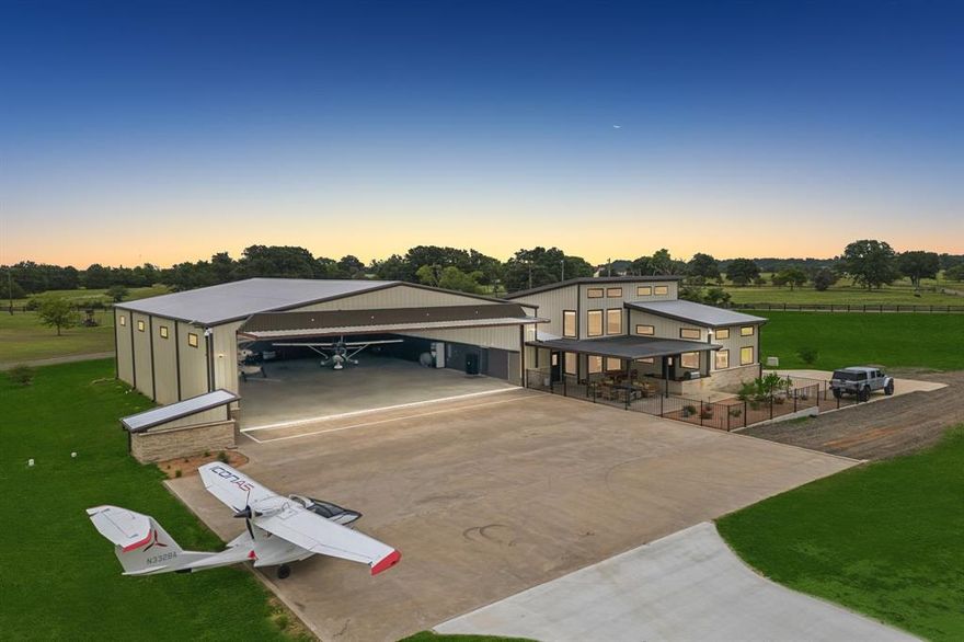 Luxury Airport Property! East Texas' Hidden Gem! Located at Delva Field Airport (00TX); boasting a 4,000' x 70' paved runway! Introducing airport living at its finest! This recently constructed 10,848 SF hangar home, situated on .96 acres, really has too much to mention! 68' wide x 78' deep climate controlled hangar with big industrial fan - plenty of room for your toys! RV, aircraft(s), boat, motorcycles, ATV's, etc. Large concrete aircraft parking apron; Higher Power Band Hydraulic Door:  hangar door opening 62' wide x 15'; Climate controlled three bay garage over 2,000 SF! Explosion proof aircraft fuel storage building attached to hangar; Indoor fitness pool and spa! 1st floor: Two living areas, Eat-in Kitchen, full bath, laundry room, hidden safe room, and runway facing outdoor kitchen and patio; 2nd floor: Massive bedroom, full bath, with two walk-in closets. All high end finishes and furnishing; no expense was spared during construction! Property looks brand new; property was used a a second weekend home and hangar. Schedule a time to fly over and check out this one of kind airport property!