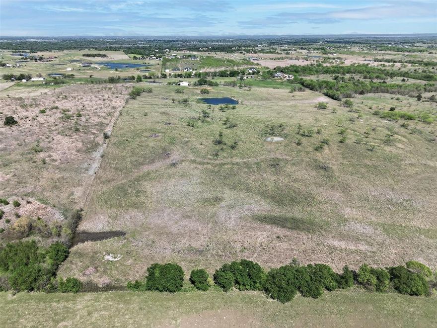 PRICED BELOW MARKET FOR A QUICK SALE - SERIOUS BUYERS ONLY. WE ARE REVIEWING OFFERS IMMEDIATELY. It is platted. 

Escape to the country on this beautiful 4.54 acre lot in Ennis, TX. Peaceful and private, this property features a creek, open pastures, and a flat, buildable area ready for your dream home or weekend getaway. Water and electric are available at the street, septic needed. No HOA or restrictions, bring your horses, build a cabin, or simply enjoy the wide-open space. Easy access to I-45 and just a short drive to the DFW metroplex. Enjoy quiet country living with convenience close by. Buyer and Buyer Agent to verify all information.