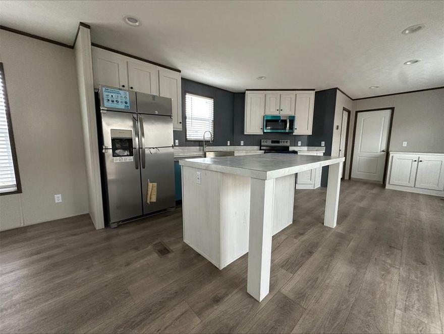 This stylish 3-bedroom, 2-bath manufactured home from Clayton Homes features the popular Resolution J model, combining comfort, functionality, and modern design. The open-concept floor plan includes a spacious living room perfect for relaxation or entertaining. The chef’s kitchen boasts sleek stainless steel appliances, including a refrigerator, stove, dishwasher, and microwave, as well as ample counter space and generous cabinet storage. The master suite is a true retreat, offering a walk-in closet and a luxurious private bath with a soaking tub and separate shower. Two additional bedrooms provide plenty of space for family, guests, or a home office. With modern finishes and upgraded fixtures throughout, this home offers a perfect balance of style and practicality.