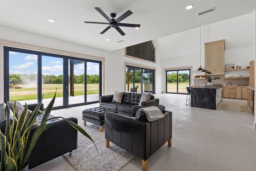 NEW BUILD - READY TO ENJOY is this very spacious 4 Bedroom 4 Bath custom built barndominium with 3 acres located on a quiet county road. This home features special touches from front to back with custom built entry and gates, micro cement flooring, custom cabinets, quartz countertops and much more!
 As you enter the extra wide vault type front door you find wide accessible hall leading to the large living area with cathedral ceilings, stained trim  and a dry bar. The custom kitchen features include an island, beautiful cabinets, quartz countertops and huge (6.5x13) walk-in pantry that has custom shelves and a sink. The large custom built windows along back of the dining area allows you to enjoy the natural lighting. Outside you will find a large covered entertainment area that could feature an outdoor kitchen, table, pool, hot tub and providing plenty of space for all if desired. The large (15x16) primary bedroom has custom bath, shower, quartz countertops and a walk-in closet with custom shelves and shoe rack. The second large bedroom also has a custom closet. The other two bedrooms have their own bath with shower. Upstairs you will find a large (28x18) game room with bamboo flooring and providing plenty of space for your imagination. Added to the floorpan as a bonus is a custom built (8x8) safe room. (Not on floorpan)
This home was designed and built with ownership in mind with spray foam insulation, easy upkeep features, all plumbing downstairs, large rooms, custom touches throughout, gated entry and about anything you could ask for in a new home. Additional acreage available.