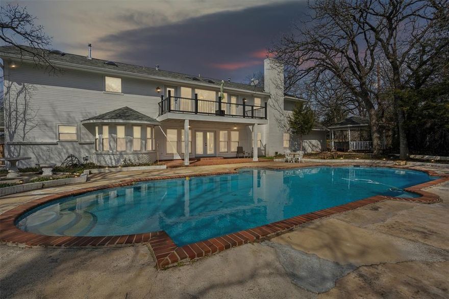 This stunning Southern plantation-style estate with separate guest house offers an unparalleled blend of grandeur and luxury set on nearly 2 acres, corner lot, in a highly sought-after location near Lake Arlington. This estate could be your next beautiful new home or easily transformed into a wedding type venue, possibilities are endless! Gated entry with iron fencing welcomes you to a circular drive where a magnificent water fountain sets the stage for the exceptional home. Step inside to a grand foyer featuring a double staircase with new marble floors leading to a breathtaking atrium with a cascading waterfall with several windows for natural light and French doors opening to the pool. Home boasts 3 bedrooms each with ensuite bathrooms plus 2 half baths, formal dining room, office, expansive family room with wet bar, game room and several beautiful chandeliers throughout the home. Updated kitchen features new flooring, granite countertops, soft close hinges and drawer slides along with new double oven and cooktop perfect for entertaining. Primary suite is a luxurious retreat with a large sitting area and oversized walk-in closet. Additional highlights include 2 new 5-ton HVAC units, new siding along the back and new gutters front and back. New Roof 2025, Pool resurfaced in 2024 along with new tile and lighting which enhances the outdoor oasis while the guest quarters are connected by a breezeway offer a fully updated 1 bed, 1 bath suite with a kitchenette and new AC unit. A 3 car garage ensures ample parking and the new balcony deck adds charm to the home's timeless elegance. Though the pool house and gazebo need some work, this estate's beauty and craftsmanship shine through, making it a RARE find in an unbeatable location!! Schedule your private tour today!! Complete list of updates available upon request.