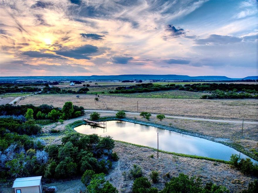 The Perfect Trifecta Ranch – Equine, Cattle, & Trophy Hunting

This exceptional 397-acre ranch in Palo Pinto County offers the rare combination of top-tier equine facilities, a productive cattle operation, and world-class hunting opportunities—all in one remarkable property. Conveniently located within reach of the DFW Metroplex, yet far enough away to enjoy the peace and privacy of true ranch living, this is a once-in-a-lifetime opportunity.

At the heart of the property sits a 1,960 sq. ft. residence, recently fully remodeled with all-new appliances and modern finishes—move-in ready and designed for comfort.

The equine facilities are second to none, featuring:
• Two horse barns, with thirteen oversized 15’ x 11’ stalls, individual turnouts, tack rooms, wash racks, and stocks.
• An extra-large fenced riding arena suitable for multiple disciplines, plus a round pen.
• A rainwater collection system serving all structures with over 30,000 gallons of storage and full filtration—ensuring a reliable water supply year-round.

For cattle operations, the ranch is perimeter and cross-fenced with two separate working facilities, complemented by a perfect mix of open pasture and wooded terrain for rotational grazing and livestock management.
Hunters will appreciate the abundant wildlife, including trophy whitetail deer, turkey, dove, duck, and varmints.  Included is a professional 100 yard shooting range, making this property a true sportsman’s paradise.

Water resources are plentiful, with six stock tanks, including one exceptionally large tank complete with a dock—each stocked for fishing and recreation.
Additional improvements include a workshop, equipment barn, and covered storage, ensuring the ranch is fully equipped for work and play.

Every detail of this ranch has been thoughtfully planned and executed—creating a property that truly must be experienced in person to be appreciated.
This is more than a ranch—it’s the ultimate lifestyle property.