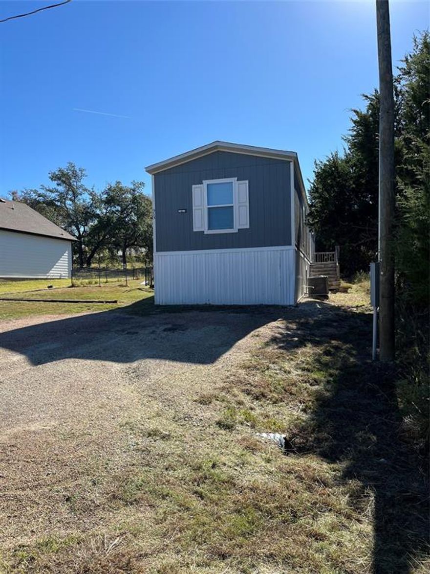 Discover this charming 2021 manufactured home nestled in the Comanche Cove community, just walking distance to the clubhouse and pool. Offering an ideal blend of comfort, and convenience, this home has 1,216 square feet and features 3 spacious bedrooms and 2 full baths, including a primary suite with an ensuite bath and relaxing garden tub. The open-concept living room boasts built-in cabinets, flowing seamlessly into an eat-in kitchen equipped with ample space for gatherings. Modern touches include durable vinyl flooring, central electric heating and cooling, ceiling fans, and abundant natural light throughout. Schedule your tour today!