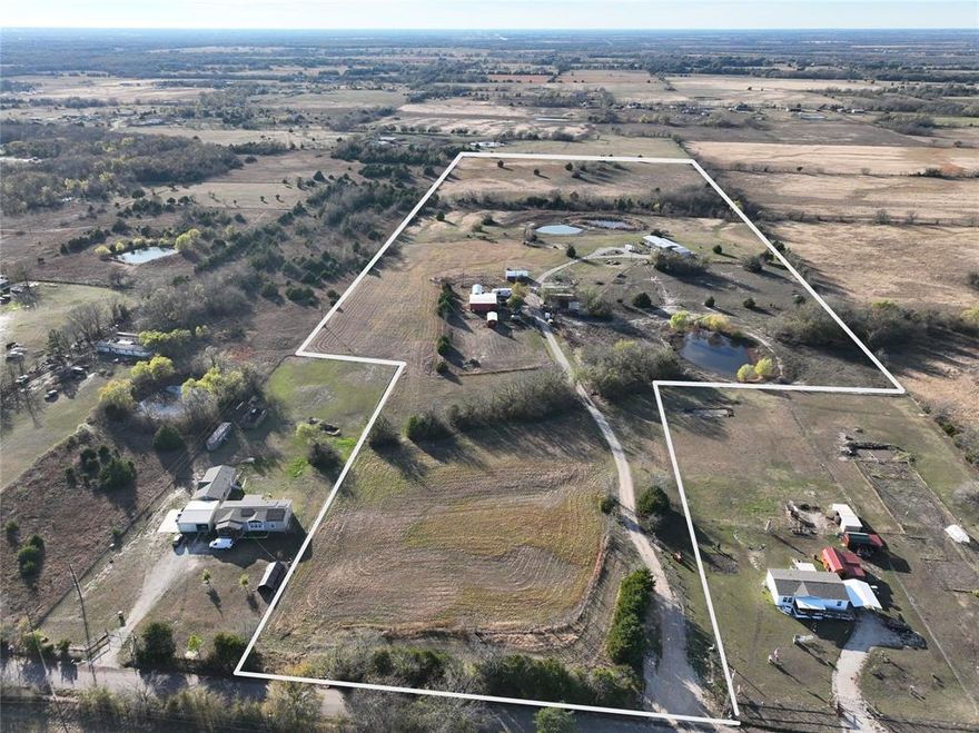 Perfect property for business and living! Discover over 33+ beautiful acres featuring a nearly new 4-bedroom, 2-bath manufactured home, approximately 2.5 years old, set back off the road with a circular driveway and a spacious 30' x 25' carport. Home also features 2 separate living areas, one with electric fireplace, split bedrooms, kitchen with island, walk in panty with plenty of storage, great views out the kitchen windows too! Large 14x60 wood deck off the back of home, perfect spot to relax! The property also includes a 40 x 30 metal shop on concrete slab with overhead door, 2 post hydraulic car lift and an attached studio apartment, perfect for guests, rental income, or workspace. A second carport, another spot (where home was) with full utilities—electric, water, and septic—marks the site of a previous home, offering a prime spot for a new residence or future expansion. A private well is located on the property. The land is fully fenced and features an attractive pipe-fenced, gated entrance along with two separate driveways, providing multiple access points and endless possibilities. Here's your chance for multi families, your dream home or a business to be planned here..... there are unlimited choices so make us an offer today!
Enjoy three ponds, one stocked with fish, and multiple picturesque sites ideal for building your dream home, guest homes, or even developing an RV park. Bring your ideas—this property offers exceptional versatility! Priced for quick sale!!
Additional Notes:
• Sellers are actively removing items; property will be fully market-ready soon.
• Leaseback may be required.
• Red and green Connex buildings may be purchased separately.
• Cattle on the property are also available for purchase.

Here's your chance for income producing or a great place to escape the hustle and bustle of the city and enjoy the country. Plenty of room for the family or families.