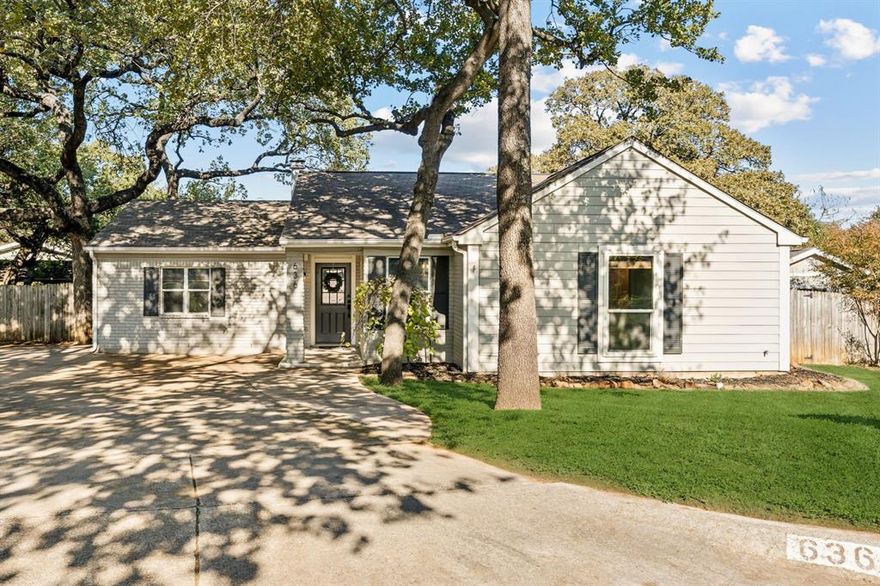 Discover this charming one-story home nestled on a beautiful, tree-lined cul-de-sac in Grapevine, the beloved Christmas Capital of Texas. Situated on nearly a quarter-acre lot, this residence offers comfort, style, and an inviting open layout perfect for everyday living and entertaining. Step inside to an open floorplan with a spacious main living area featuring a cozy fireplace and ceiling fan, seamlessly connected to the updated kitchen. The kitchen boasts granite countertops, a breakfast bar, white cabinetry, subway tile backsplash, stainless steel appliances, a convenient butler’s pantry, and additional open shelving for storage and display. Enjoy the welcoming covered front porch, then head out back through the French doors to a gorgeous, covered patio complete with a ceiling fan—ideal for relaxing year-round. The large backyard includes a storage building with electricity, raised garden beds equipped with a drip system, and plenty of room for pets, play, or future outdoor enhancements. An extended driveway provides additional parking convenience. This three-bedroom, two-bath home is enhanced with luxury vinyl plank flooring, decorative lighting fixtures, and thoughtful updates throughout. Located in the heart of Grapevine, you’ll appreciate the charming community atmosphere, local events, and easy access to restaurants, shopping, parks, and top-rated schools. A wonderful opportunity to own a beautifully updated home on a spacious lot in one of Grapevine’s most sought-after pockets. Move-in ready and full of character—this home truly has it all.