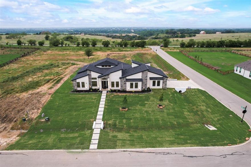 PRICED REDUCED!!!

Modern Transitional Masterpiece in The Highlands of Northlake
1700 Hamilton Ln - 4 Beds - 4.5 Baths - Single-Story - 1-Acre Lot

Welcome to a stunning new construction by Grandeur Builders, known for their commitment to exceptional craftsmanship and refined design. This Modern Transitional home offers a seamless blend of sophistication and comfort, thoughtfully laid out in a single-story floor plan ideal for families and entertainers alike.

From the moment you enter, you’ll notice the attention to detail—engineered wood floors run throughout the home, creating a clean, cohesive look with no carpet anywhere.

The heart of the home is a chef-inspired kitchen featuring premium JennAir appliances, including a built-in refrigerator and custom cabinetry extending into a walk-in pantry. The open-concept living area is filled with natural light, while a versatile game room, private home office, and elegantly appointed media room provide ample space for work and play.

The primary suite is a true sanctuary, showcasing luxurious gold-accented finishes and a spacious walk-in closet with custom built-ins.

Step outside to a fully equipped outdoor kitchen and covered living area, perfect for hosting gatherings or relaxing in style.

Situated in The Highlands of Northlake, this home offers a serene suburban setting just 20 minutes from DFW Airport and 30 minutes from Downtown Fort Worth—a perfect balance of convenience and luxury living in one of Texas’ fastest-growing communities.